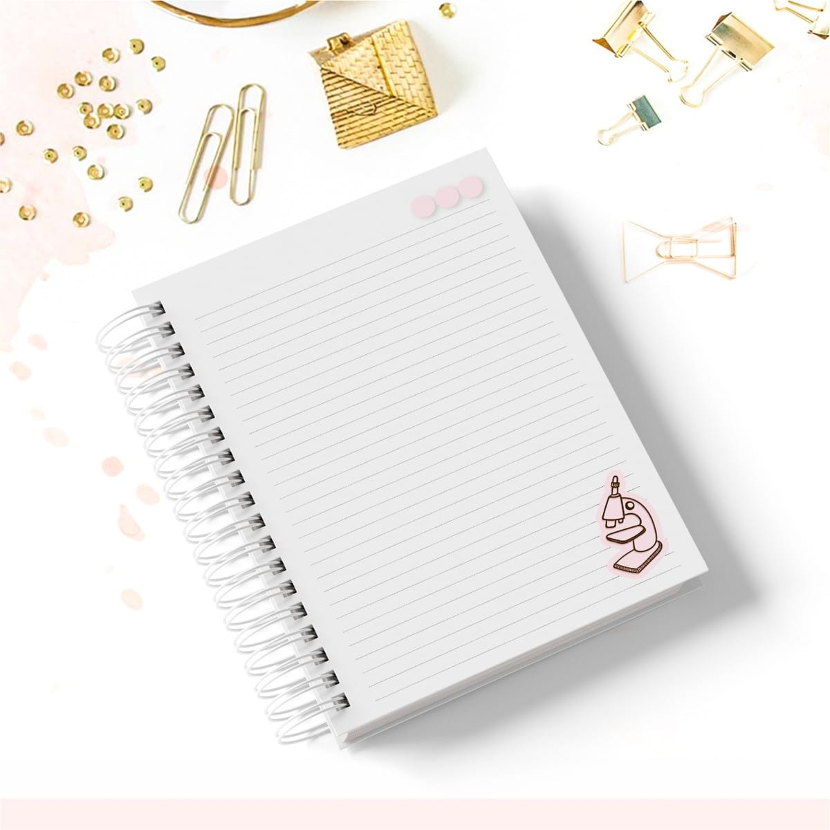 Caderno Tema Biologia Kit Digital com Capa e Miolo Pautado 2 Caderno espiral branco com páginas pautadas e ilustração de microscópio, cercado por objetos dourados.