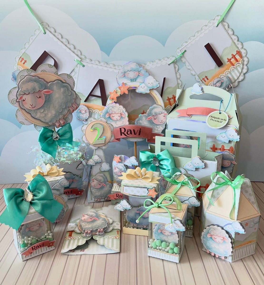 Kit Festa Ovelhinha Verde Luxo em Studio e PDF para Editar 1 Itens de festa com tema de ovelhas, nuvens, laços, números e o nome "Ravi".