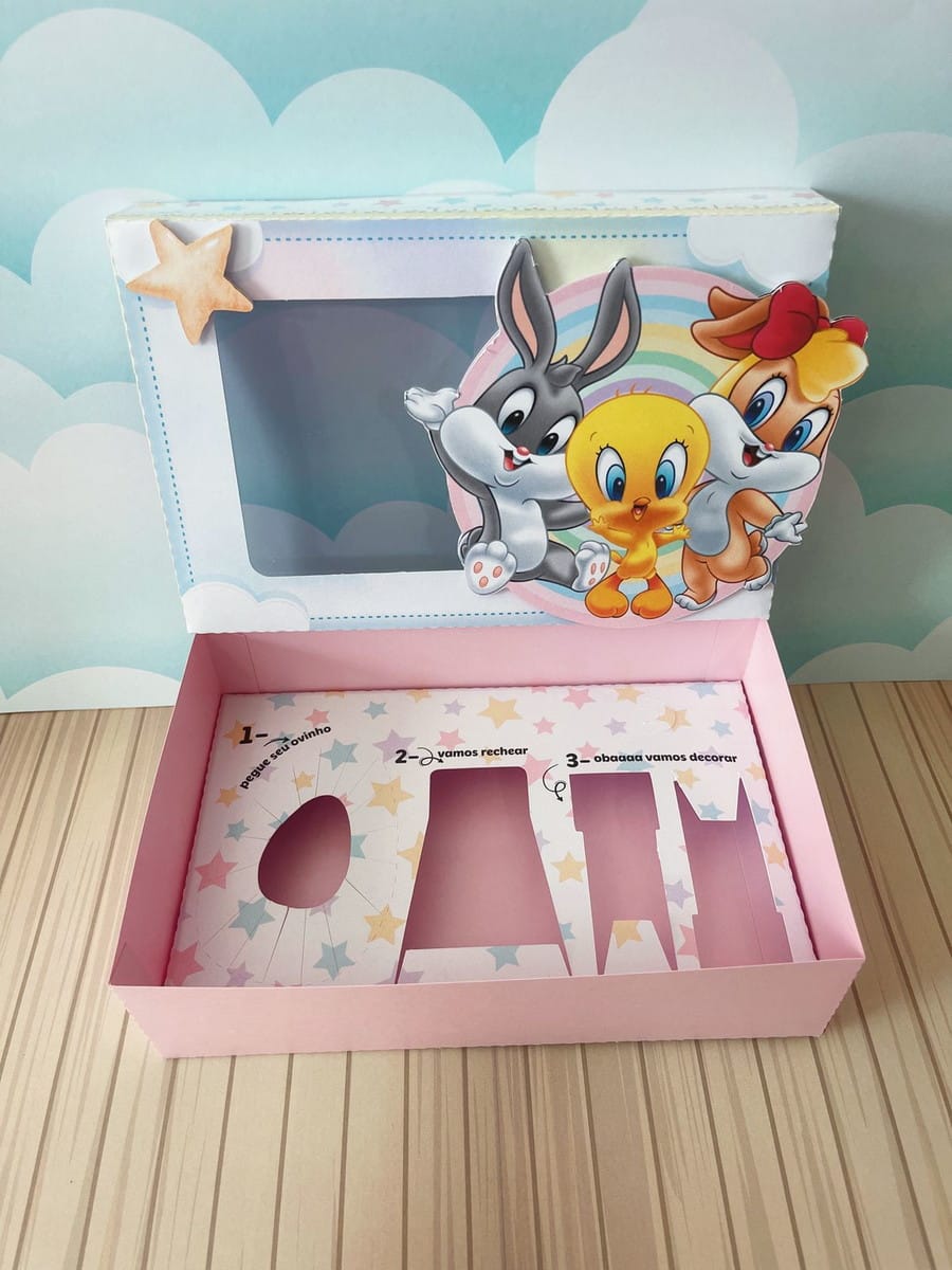 Caixa Mini Confeiteiro Looney Tunes em PDF e Studio 1 Caixa decorativa rosa com personagens de desenho animado e instruções para rechear.