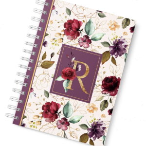 Caderno espiral com estampa de flores coloridas e letra dourada centralizada na capa.